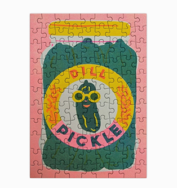 Jigsaw puzzle with a pickle design on a pink background