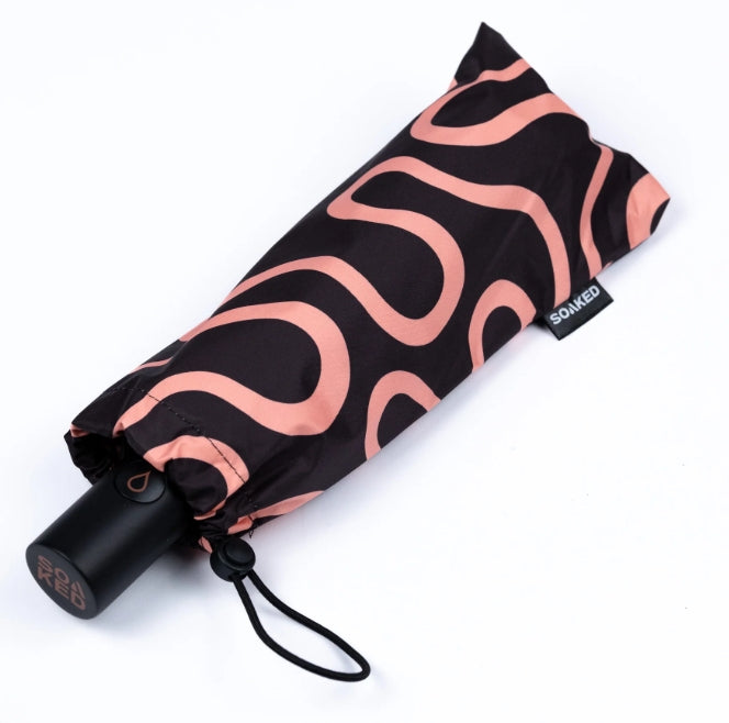 Foldable umbrella with pink wavy pattern on a white background