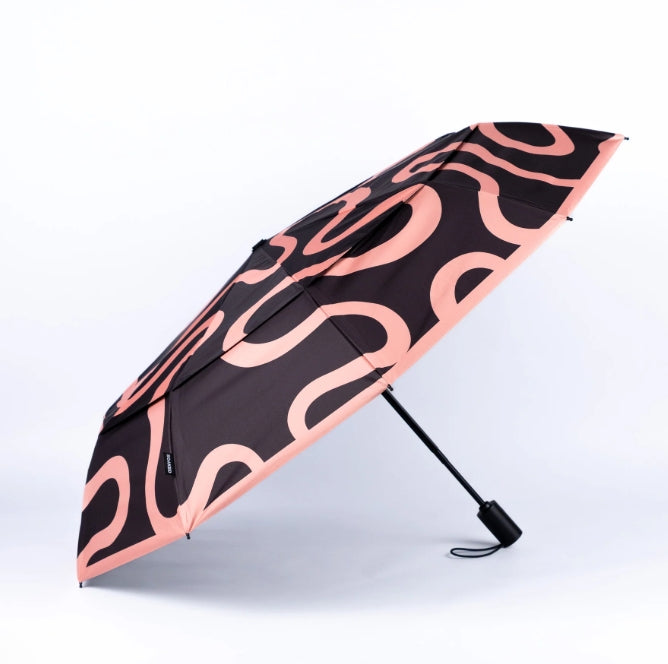 Black umbrella with pink wavy pattern on a white background