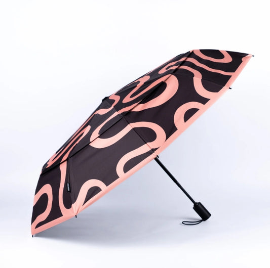 Black umbrella with pink wavy pattern on a white background